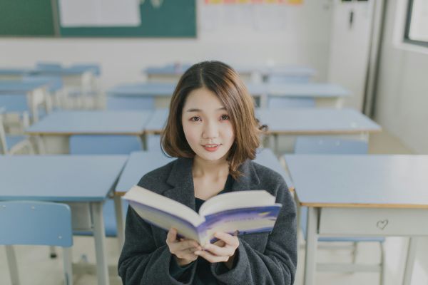 A girl looking up from a book.